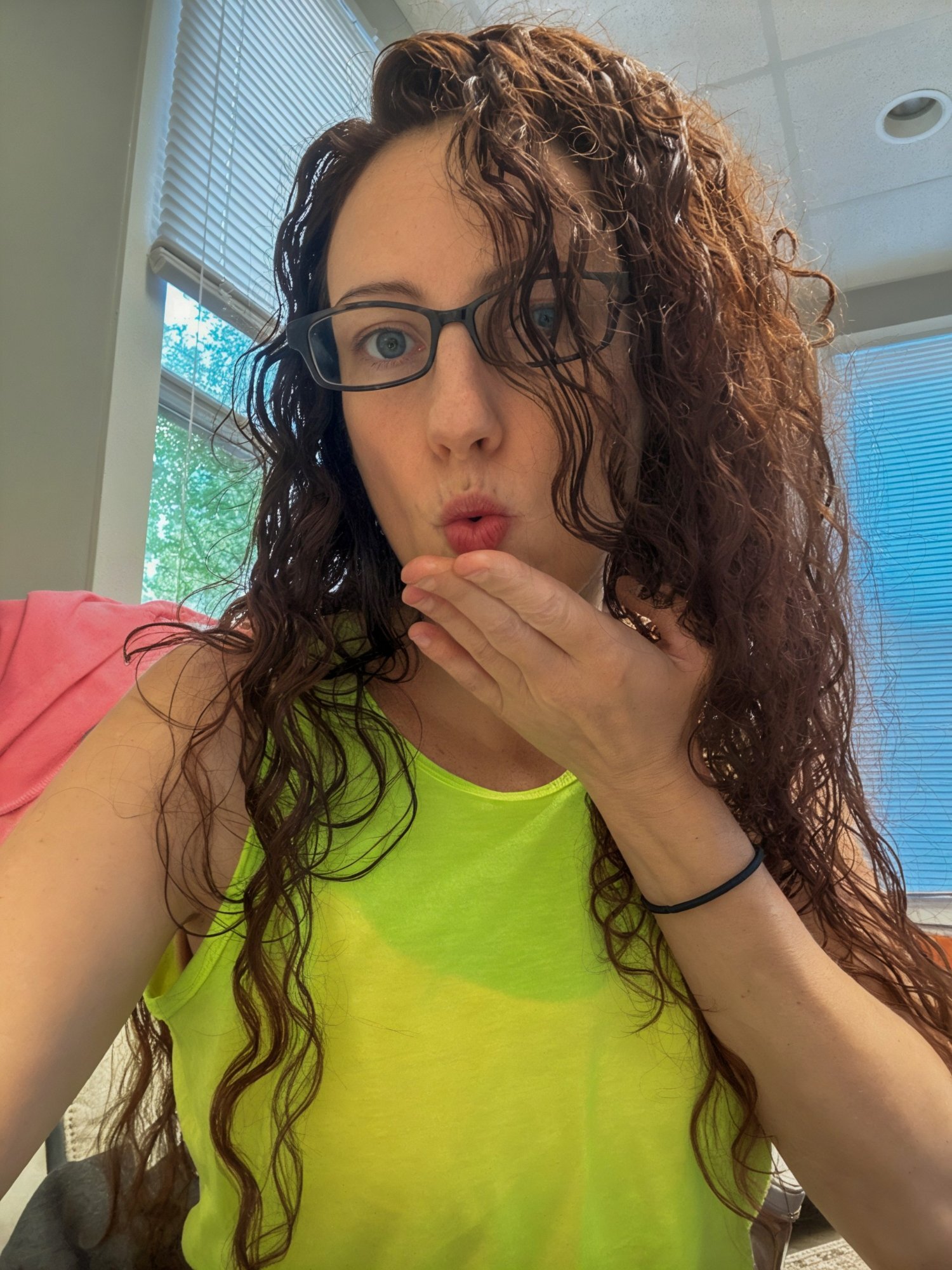 Alice Seal portrait with curly hair and glasses